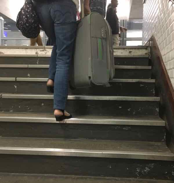 Climbing flights of stairs in the Paris Metro.