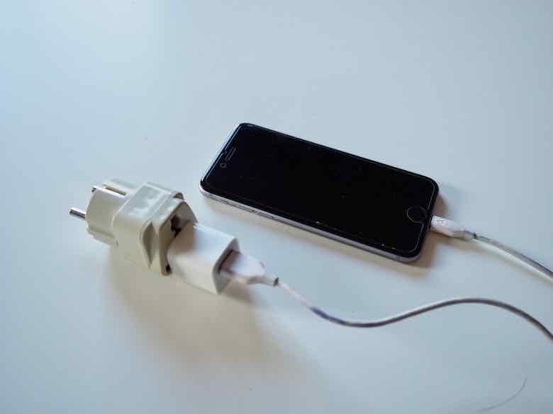 Smartphone charging into electrical outlet