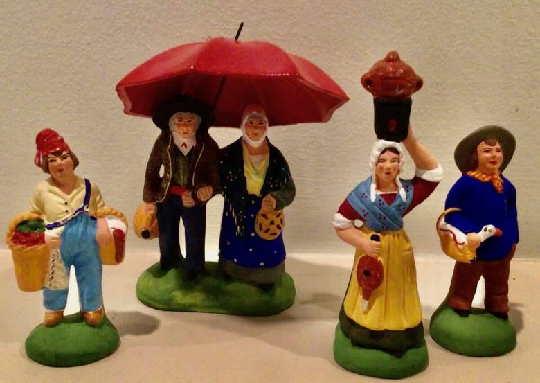 Santons: Bartholomew, couple with an umbrella, woman with a stove, and a man with a goose.